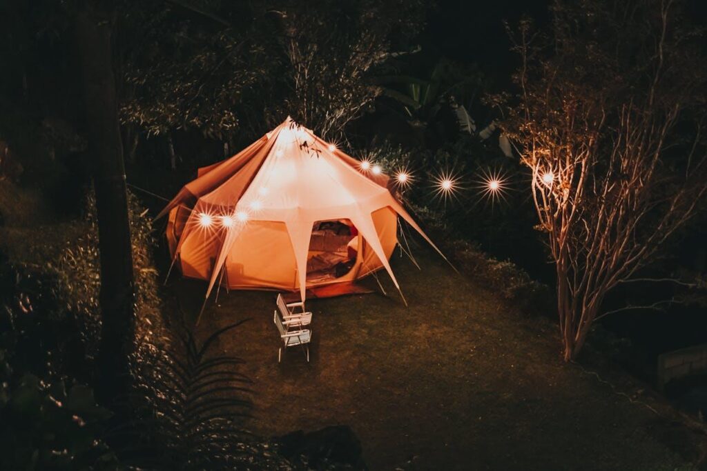 Tent at nighttime, foldable seats, fairy lights, outdoors
