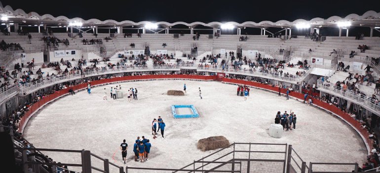 a lively scene at an indoor sports arena filled with spectators and participants at night