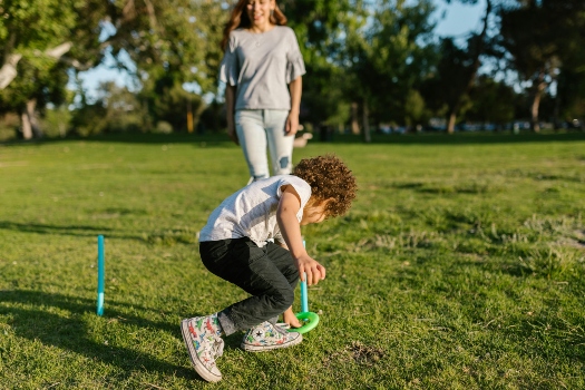 a mother and son playing outside